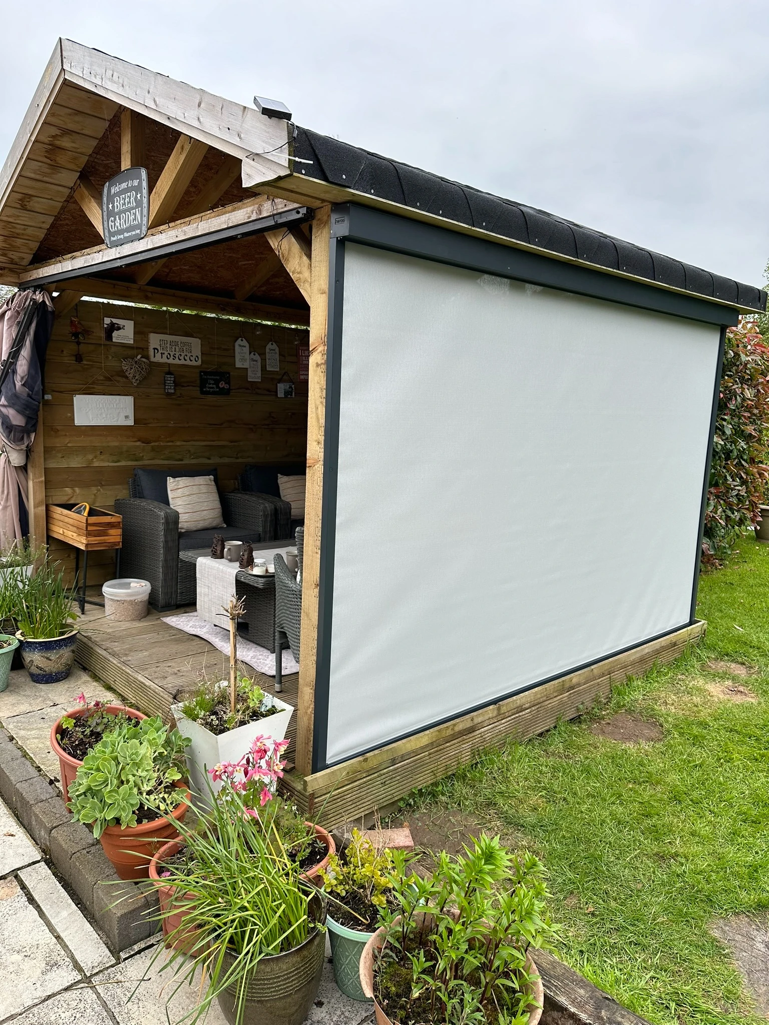 Dark motorised ZIP screen fitted to a residential garden structure in Ireland